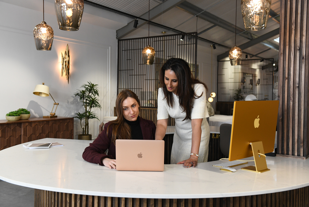 Two business women working in a laptop