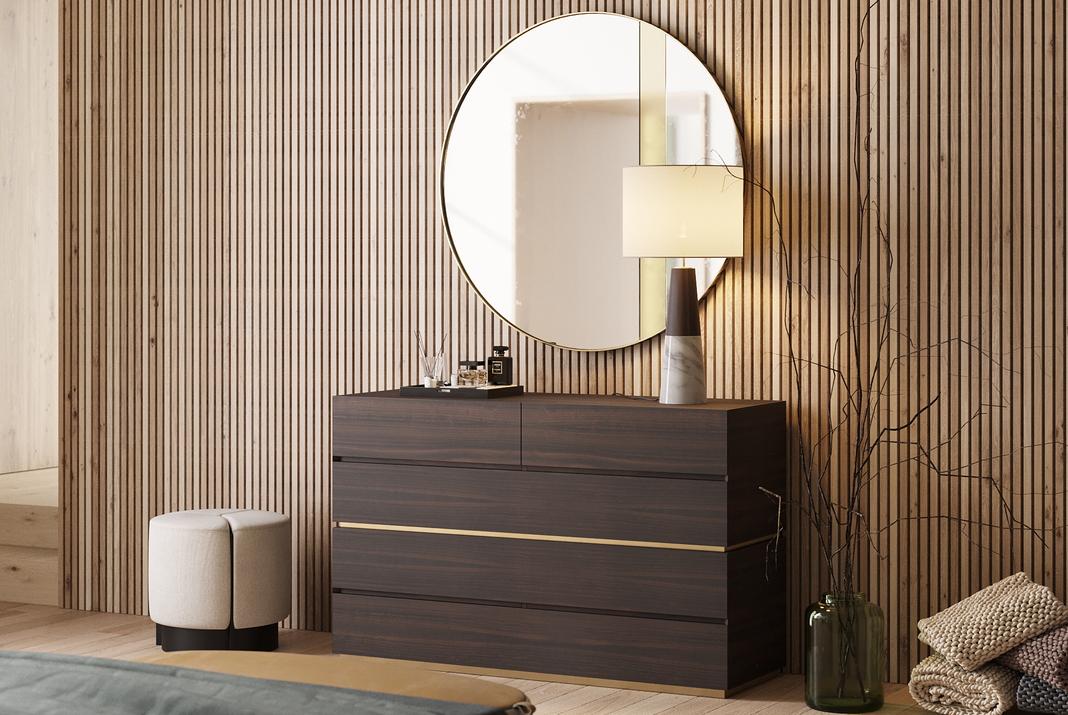 Wooden wall panels behind a circular mirror and a wooden chest of drawers