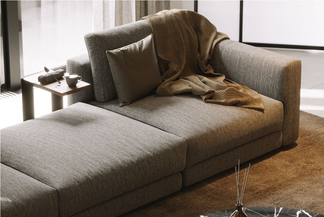 Grey sofa with a side table and a blanket