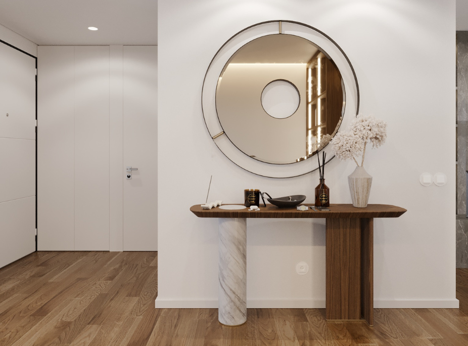 Hall de entrada moderno com consola em nogueira e pé em mármore, espelho circular de grande dimensão com moldura metálica e detalhe dourado, projeto Laskasas