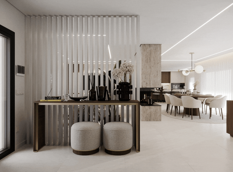 Hall de entrada com consola em metal dourado, separador em lâminas verticais brancas e ligação visual para zona de jantar, projeto Laskasas