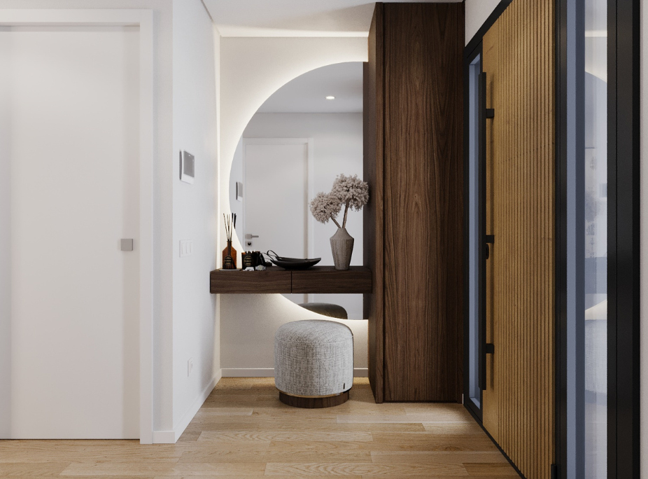 Hall de entrada minimalista con consola suspendida en madera oscura, espejo en arco retroiluminado y armario integrado en nogal, proyecto Laskasas