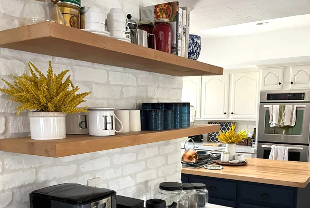 Two corner shelfs with mugs and plants in a kitchen