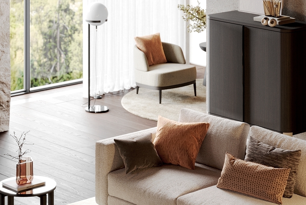 Lounging area with and armchair and a sofa with Peach Fuzz pillows