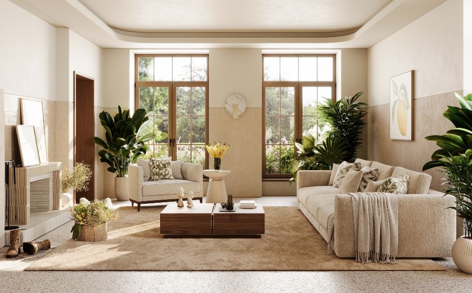 A living room filled with natural light, featuring a beige sofa, an armchair, a wooden coffee table, and several indoor plants.
