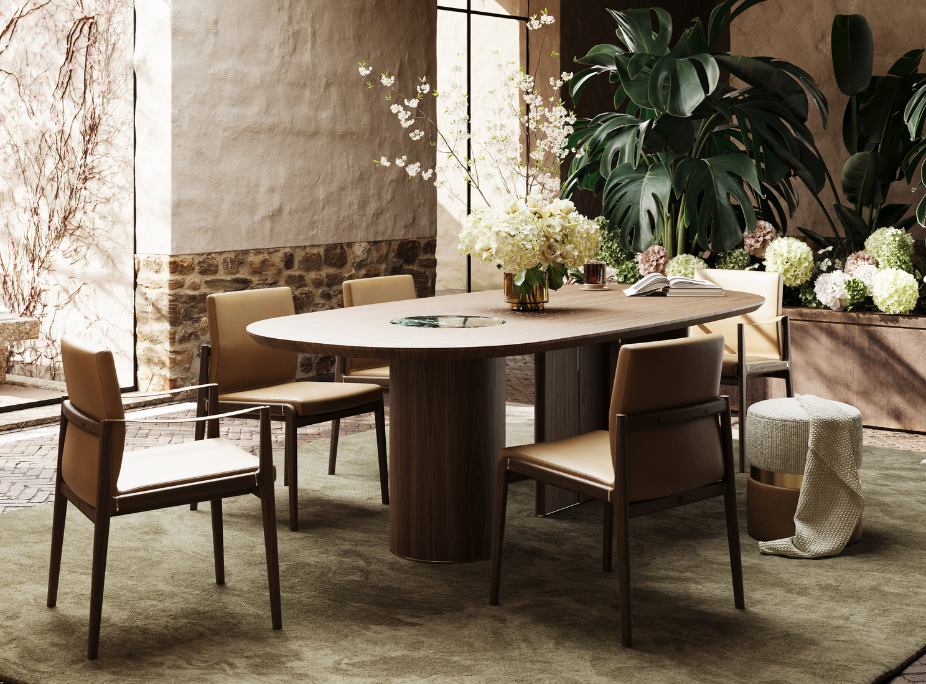 Perspectiva de una mesa de comedor de madera con forma ovalada fluida. La base cilíndrica robusta sostiene el sobre liso de manera escultórica. Sillas de diseño depurado y plantas exuberantes rodean la zona de comedor. Una estética inspiradora y en perfecto equilibrio funcional.